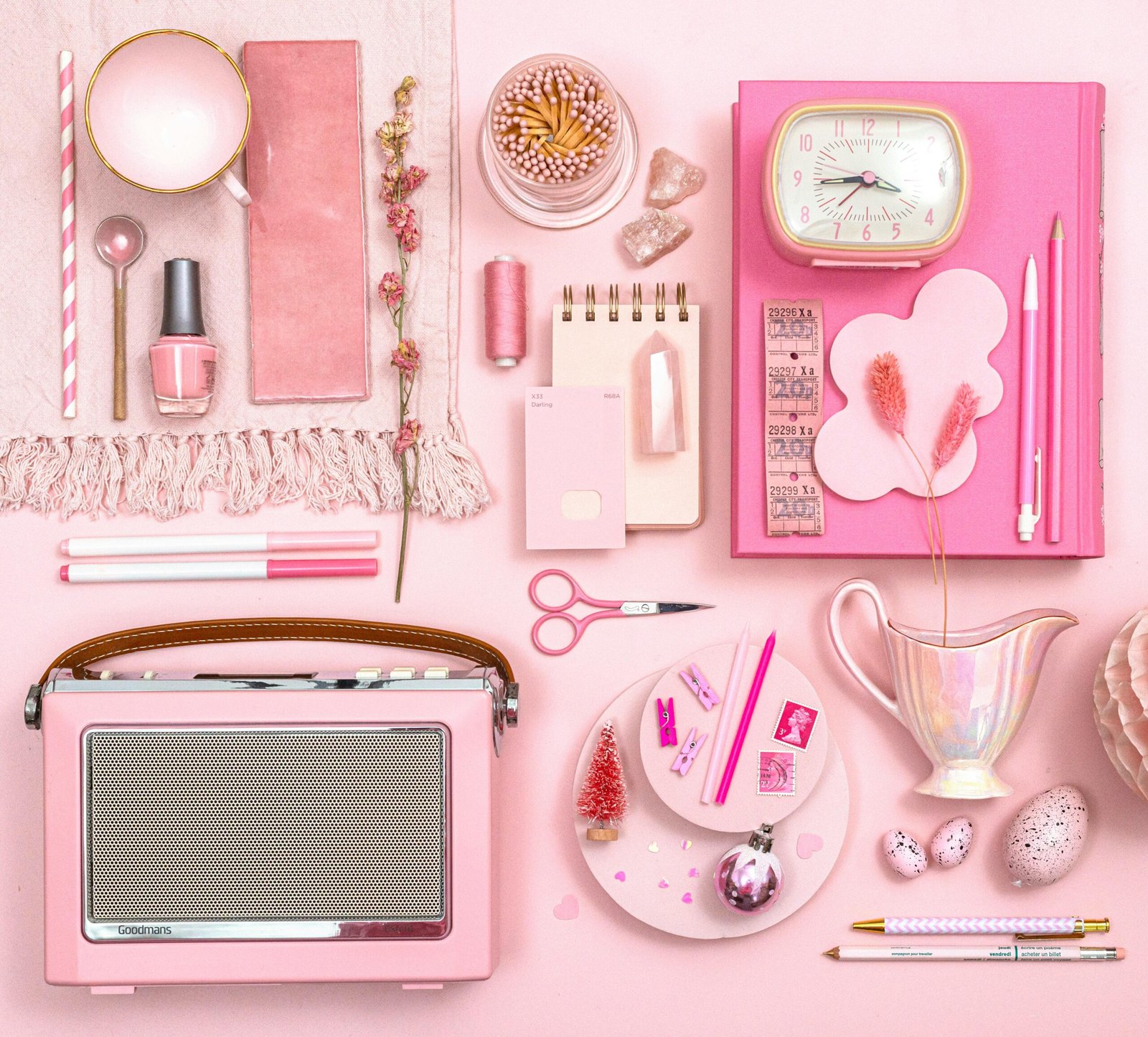 A stylish flat lay of pink stationery and decor, perfect for a feminine aesthetic.